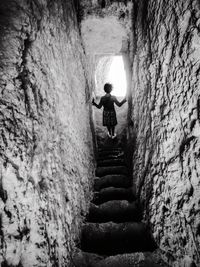 Rear view of woman on staircase