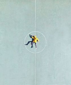 Directly above shot of man lying on playing field
