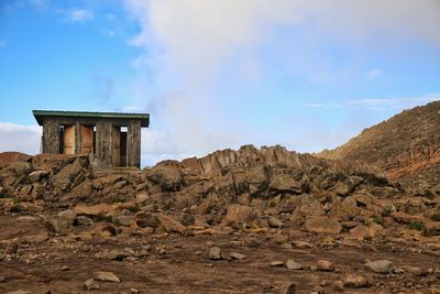 Ruins of building against cloudy sky