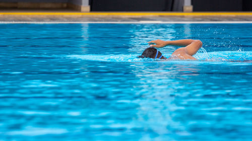 Man swimming in pool