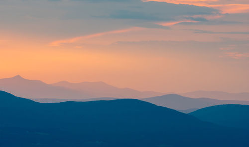 Scenic view of silhouette mountains against sky during sunset