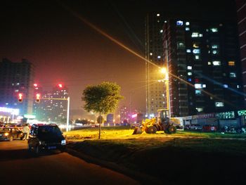 Cars on city street at night