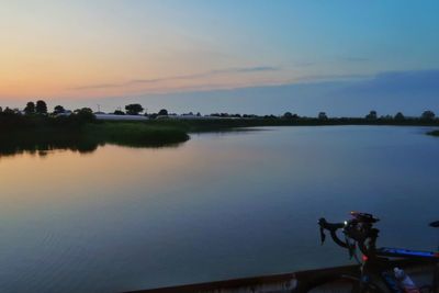 Scenic view of lake against sky during sunset