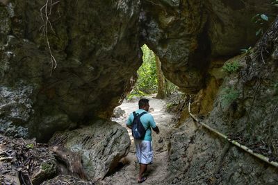 Rear view of man standing on rock