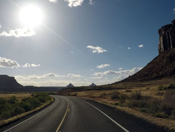 Road amidst landscape against sky