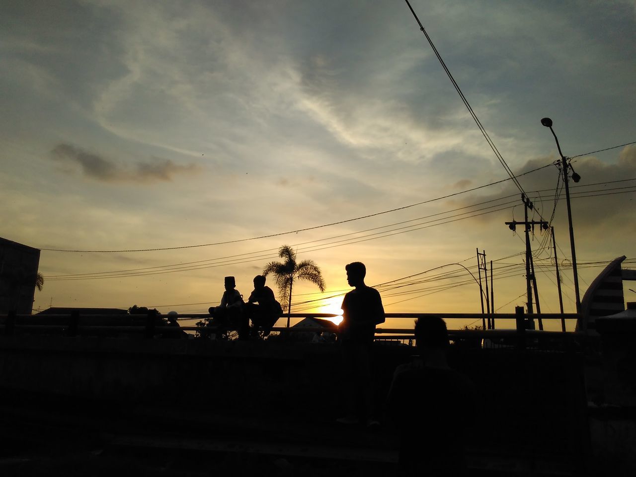 SILHOUETTE PEOPLE AGAINST SKY AT SUNSET