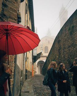 People walking on sidewalk in city