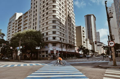 Rear view of man walking on road in city