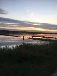 Scenic view of lake against sky during sunset