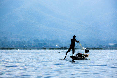 Man rowing boat in lake