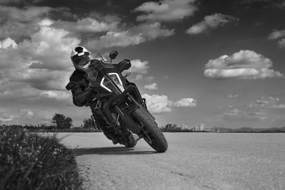 Low angle view of man on motorcycle against sky