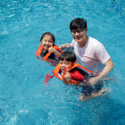 Portrait of smiling young woman swimming pool