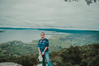 Portrait of man standing against sky