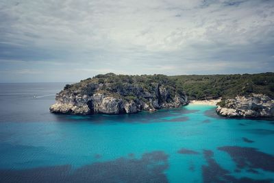 Scenic view of rocks in sea against sky