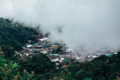 High angle view of buildings and trees against sky