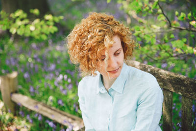 Thoughtful woman looking away while sitting in park