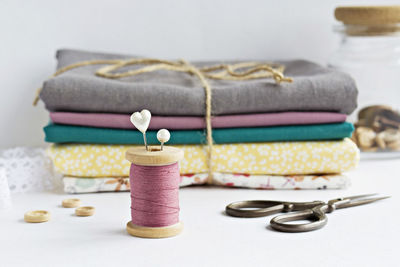 Close-up of sewing item and textiles on table