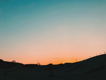 Scenic view of silhouette landscape against clear sky during sunset