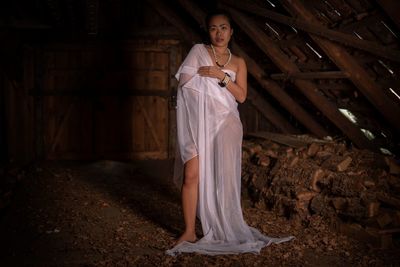 Portrait of woman wrapped in textile at darkroom