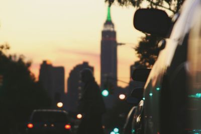 Person photographing city at sunset