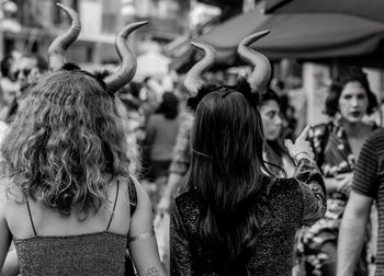 Rear view of people enjoying at street