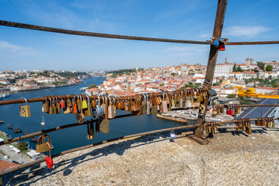 Boats moored on river by buildings in city against sky