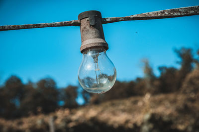 Close-up of light bulb against clear sky