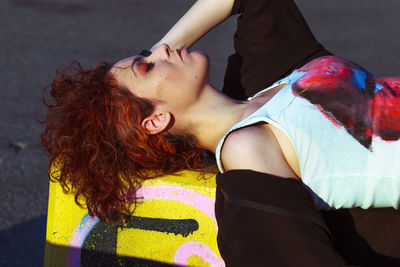 Fashion model lying on bollard