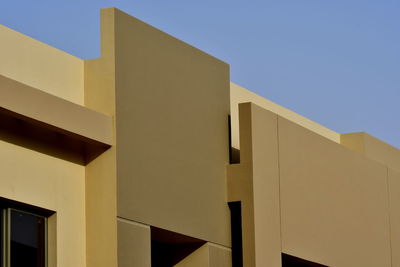 Low angle view of building against clear blue sky