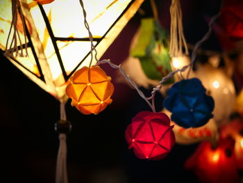 Close-up of illuminated lanterns hanging at night