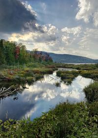 Scenic view of lake and mountains against sky