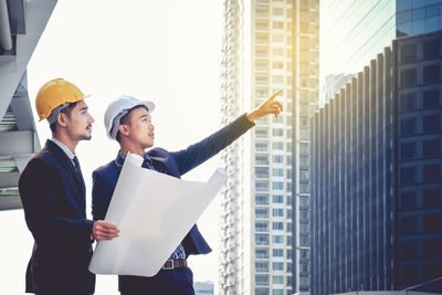 People working in front of office building