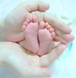 Hands holding baby feet