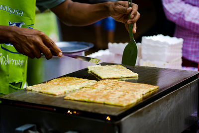 Midsection of person preparing food on table