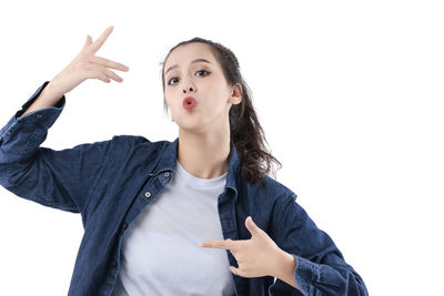 Portrait of beautiful young woman against white background