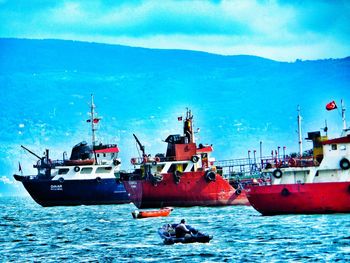 Boats in sea against sky