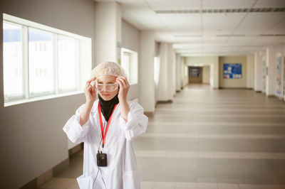 Female doctor standing in hospital lobby