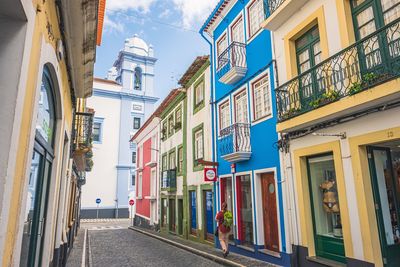 Street amidst buildings against sky