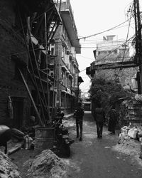 Rear view of people walking on building in city