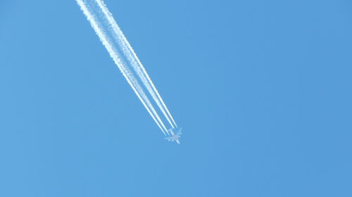 Low angle view of vapor trails in sky