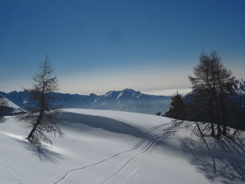 Scenic view of snow covered landscape against clear sky