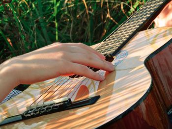 Cropped hand playing guitar