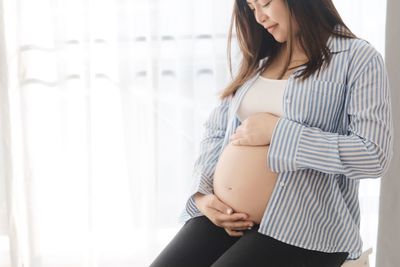 Midsection of woman touching hair