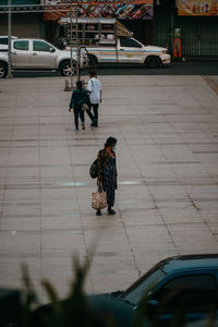 People walking on sidewalk in city