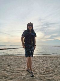 Full length portrait of man standing on beach