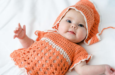 Portrait of cute baby girl sleeping on bed