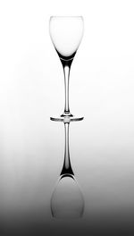 Close-up of water drop on table against white background