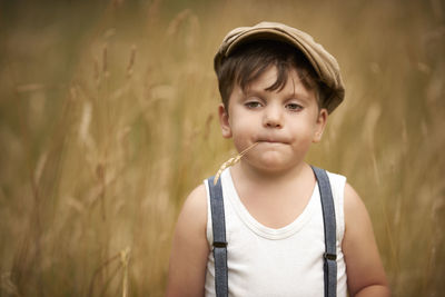 Close-up of cute boy standing against plants