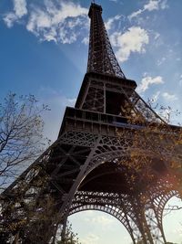 Low angle view of tower against cloudy sky