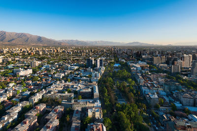 High angle view of city against blue sky